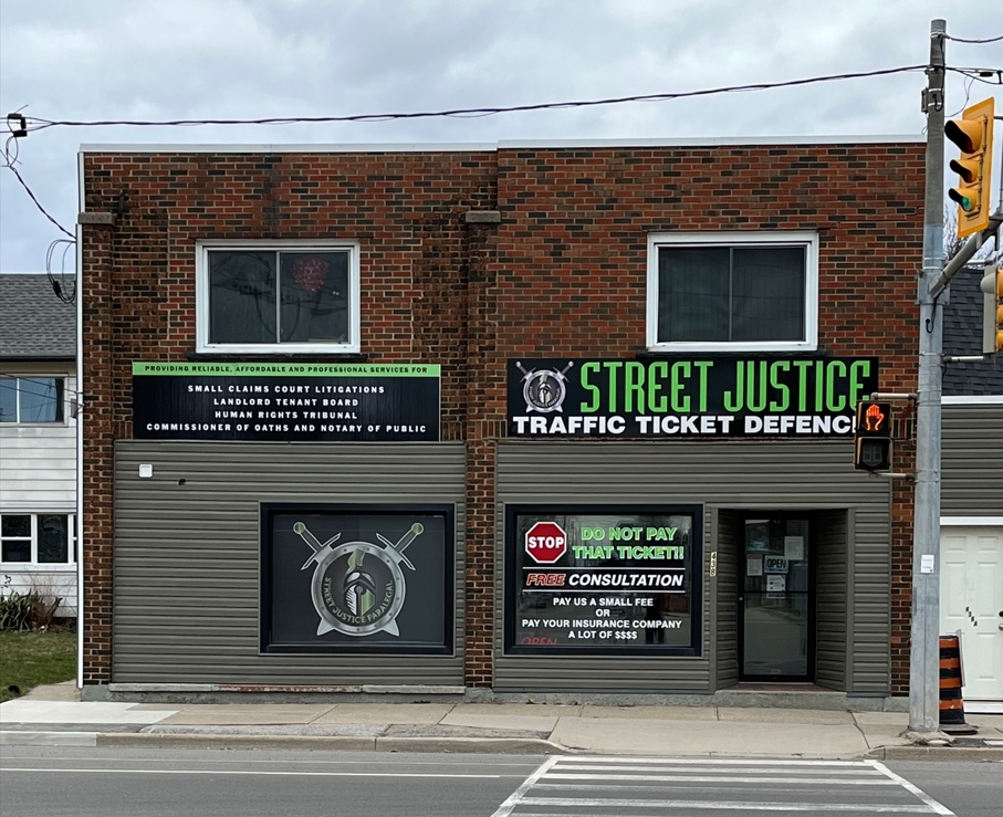 welland Street Justice Paralegal Welland office exterior featuring signage for traffic ticket defense, small claims court litigation, landlord tenant board services, and free consultation offers.